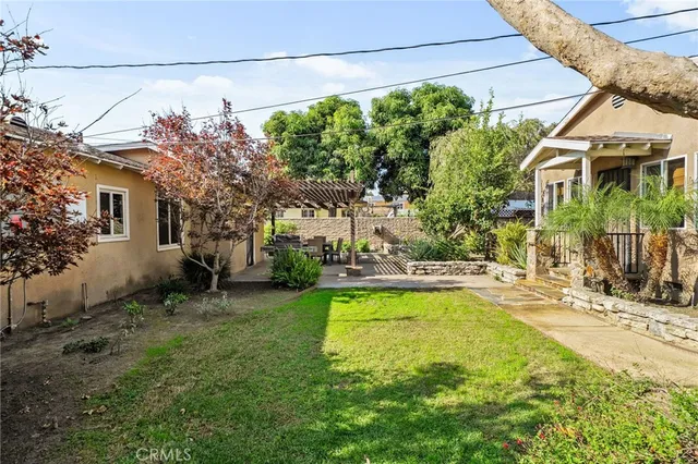 a view of a house with swimming pool and sitting area