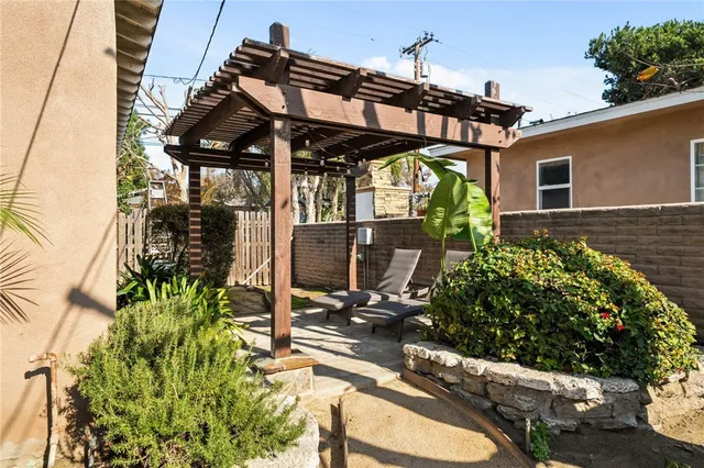 a view of a patio with table and chairs potted plants