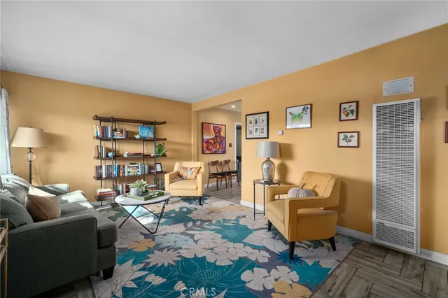 a living room with furniture a rug and a wall painting