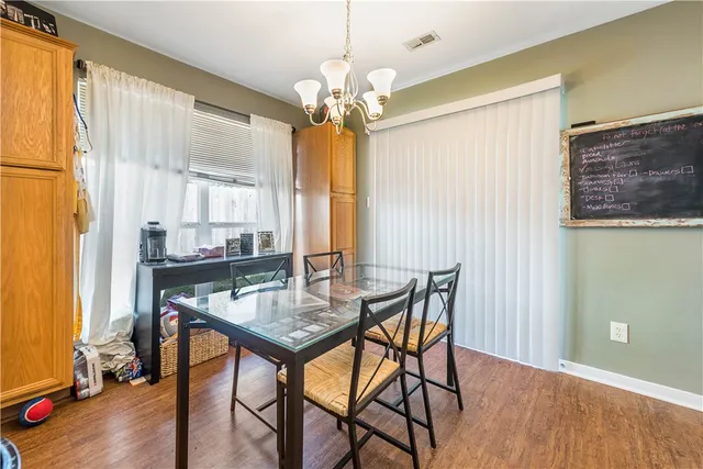 a kitchen with stainless steel appliances granite countertop a stove a sink a refrigerator and a dining table