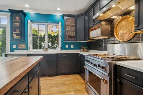 a kitchen with a stove a sink and a window