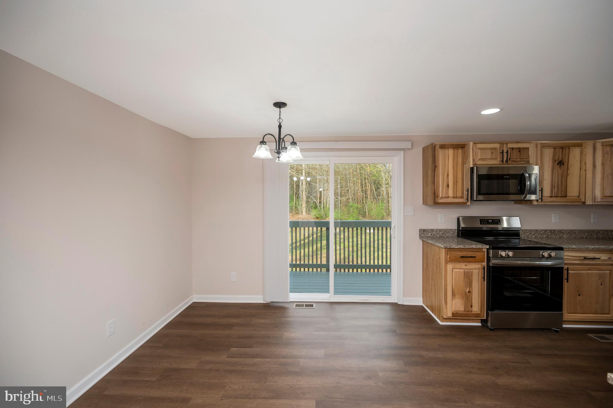 5200 Hams Ford Road Woodford, VA 22580 - Photo 11 of 51 a view of a kitchen with a sink microwave and cabinets