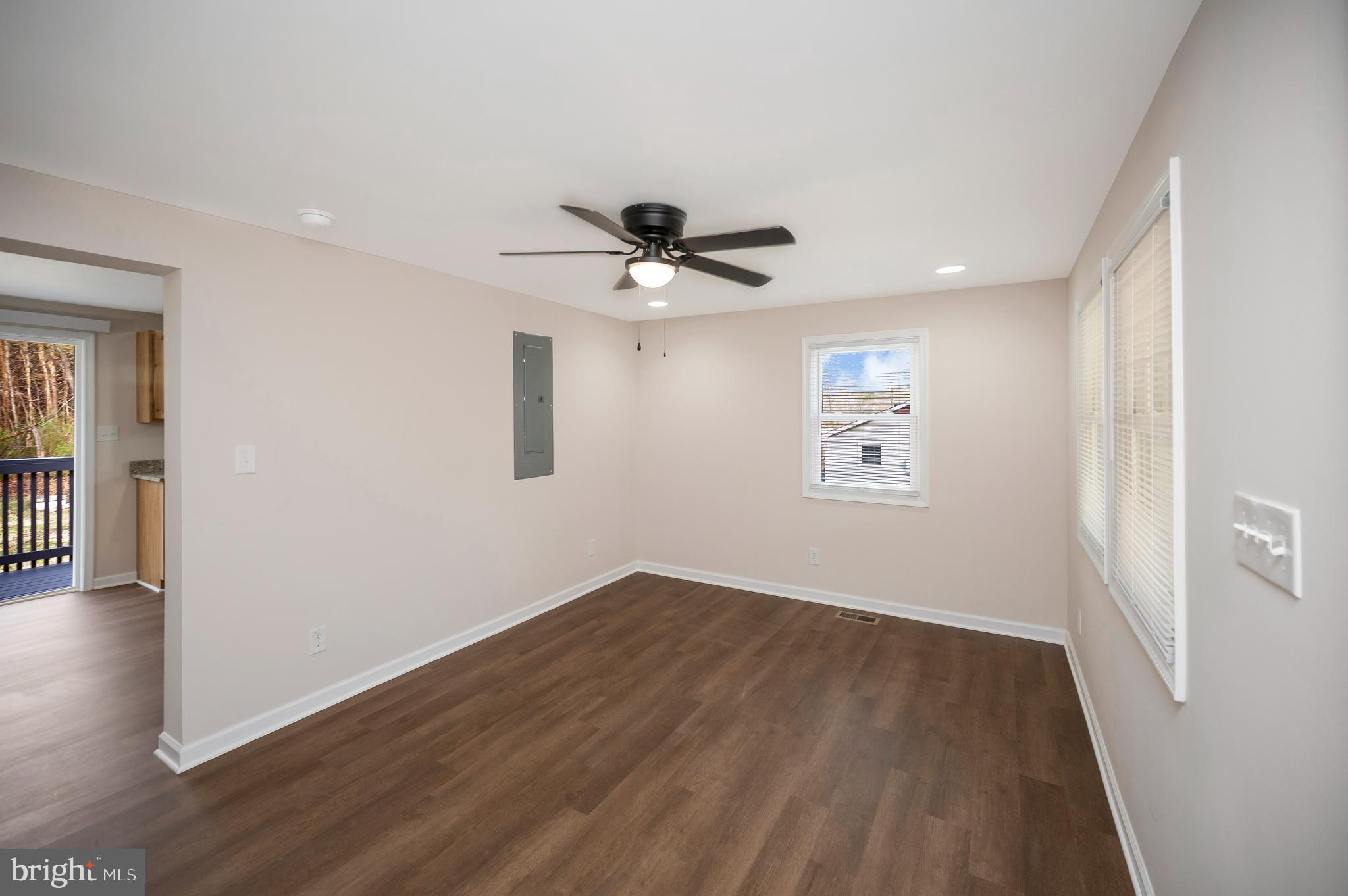 5200 Hams Ford Road Woodford, VA 22580 - Photo 14 of 51 an empty room with wooden floor and ceiling fan