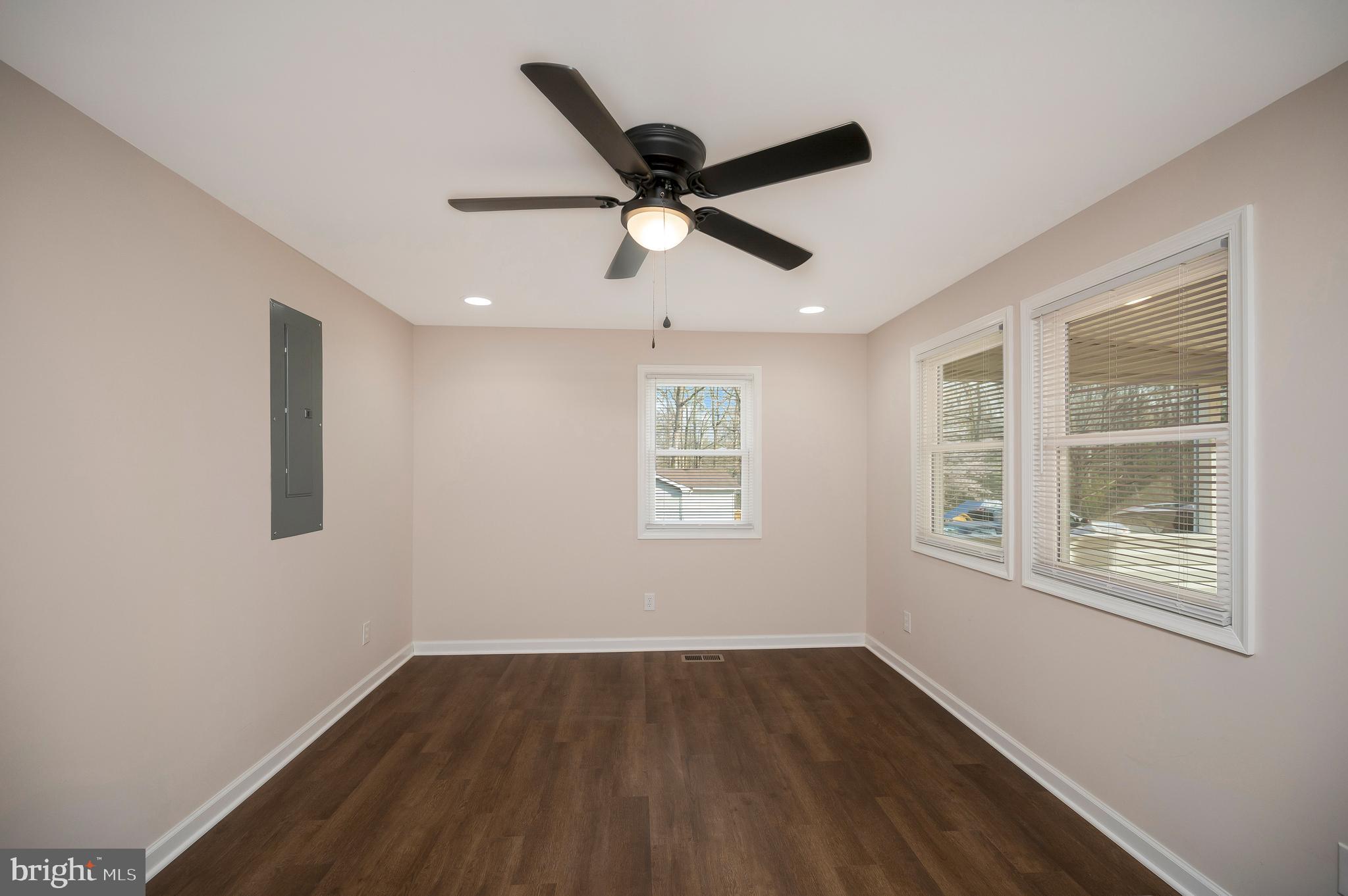 5200 Hams Ford Road Woodford, VA 22580 - Photo 15 of 51 a view of empty room with wooden floor and fan