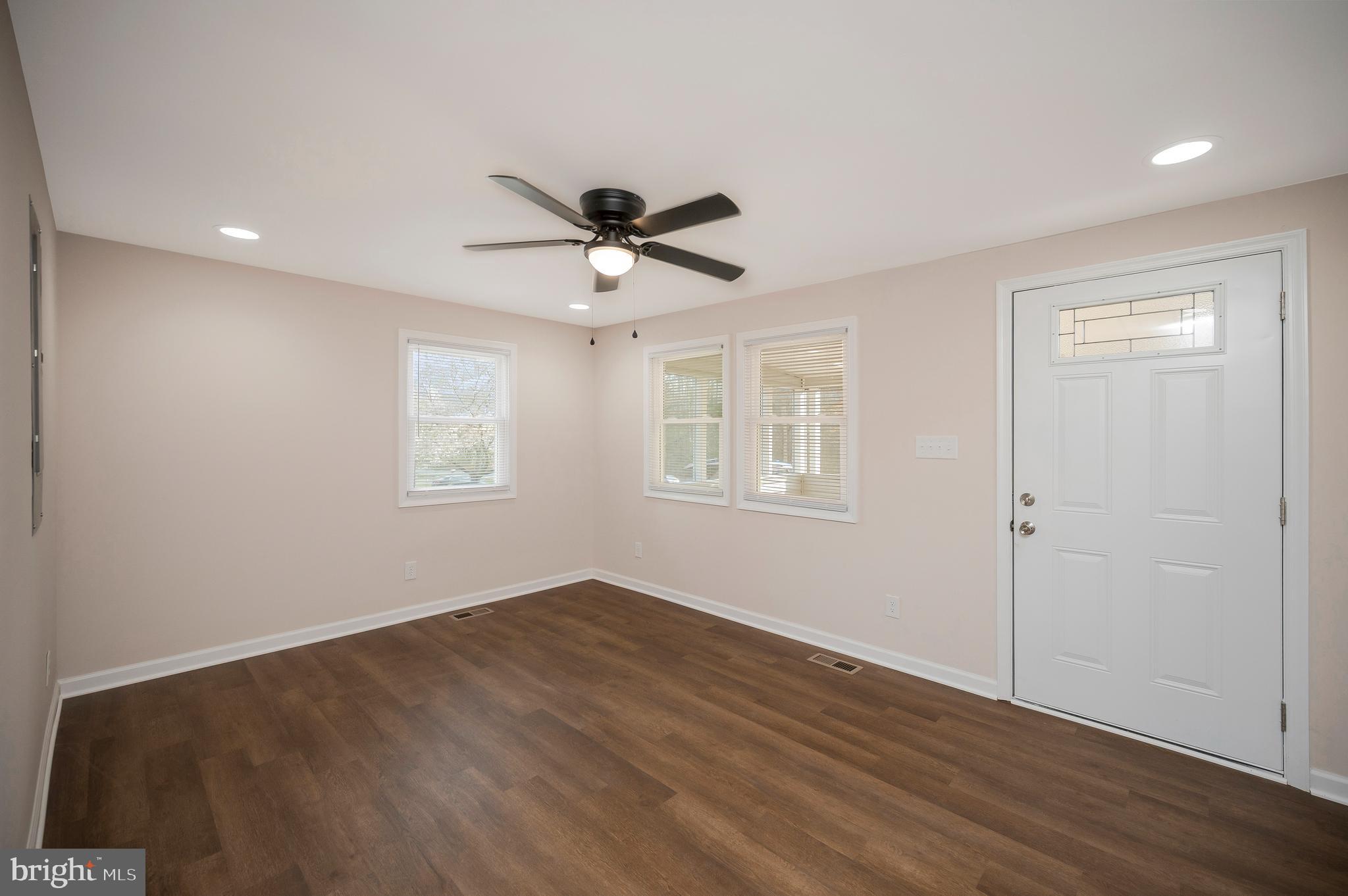 5200 Hams Ford Road Woodford, VA 22580 - Photo 16 of 51 a view of a big room with wooden floor and windows