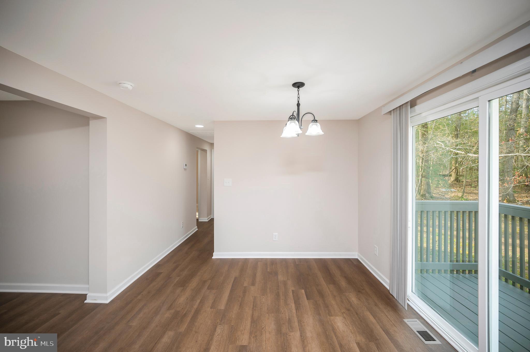 5200 Hams Ford Road Woodford, VA 22580 - Photo 18 of 51 a view of empty room with wooden floor and fan