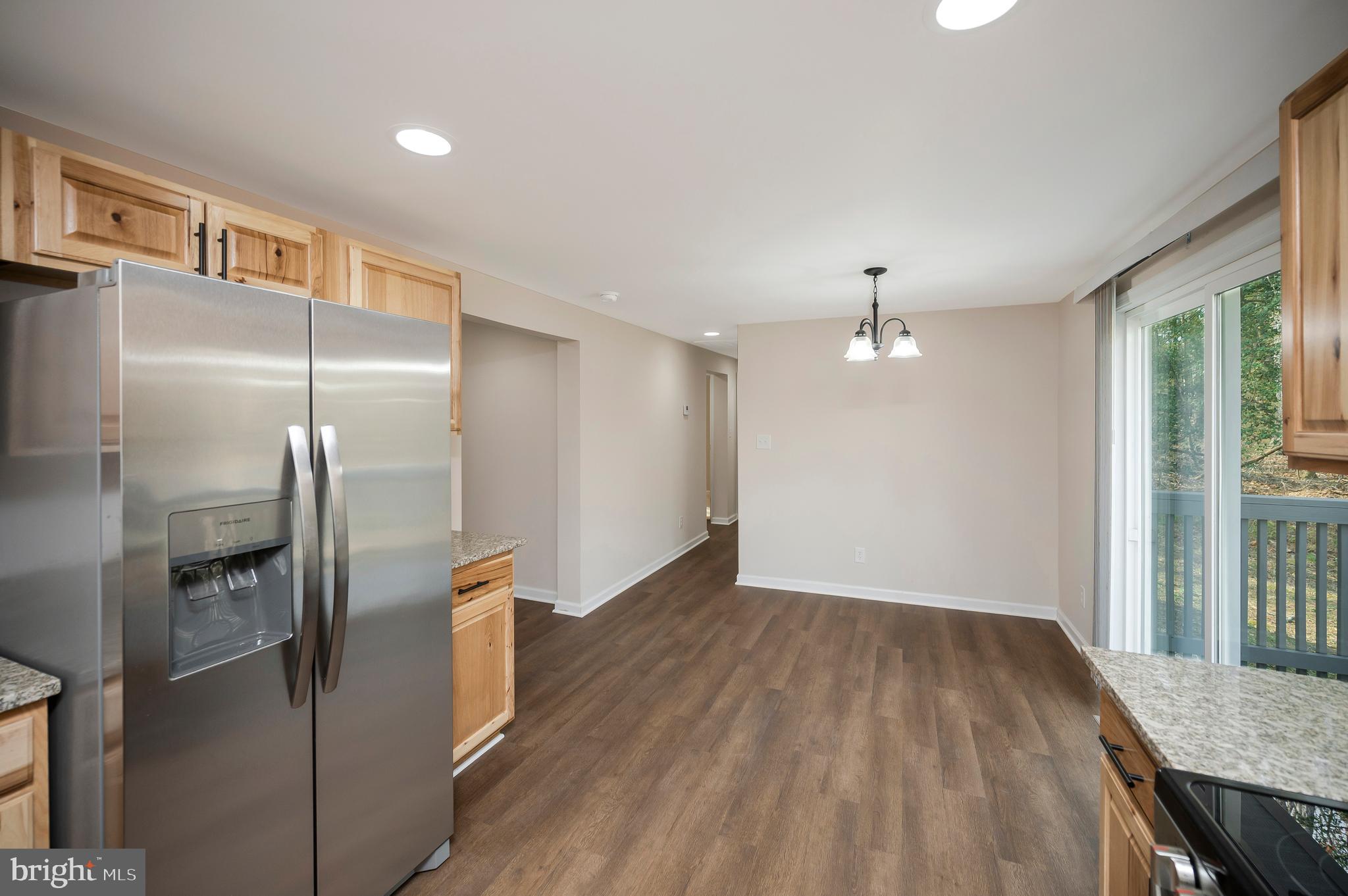 5200 Hams Ford Road Woodford, VA 22580 - Photo 19 of 51 a view of a refrigerator in kitchen and wooden floor