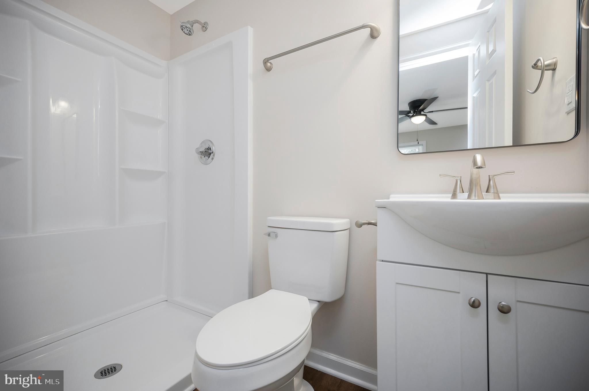 5200 Hams Ford Road Woodford, VA 22580 - Photo 23 of 51 a bathroom with a toilet a sink and mirror