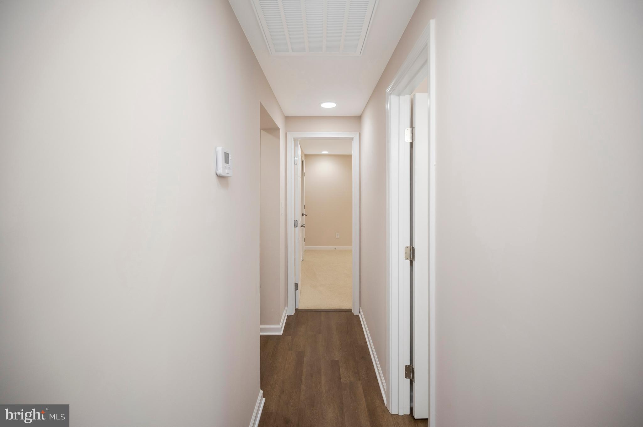 5200 Hams Ford Road Woodford, VA 22580 - Photo 24 of 51 a view of a hallway with wooden floor and a bathroom