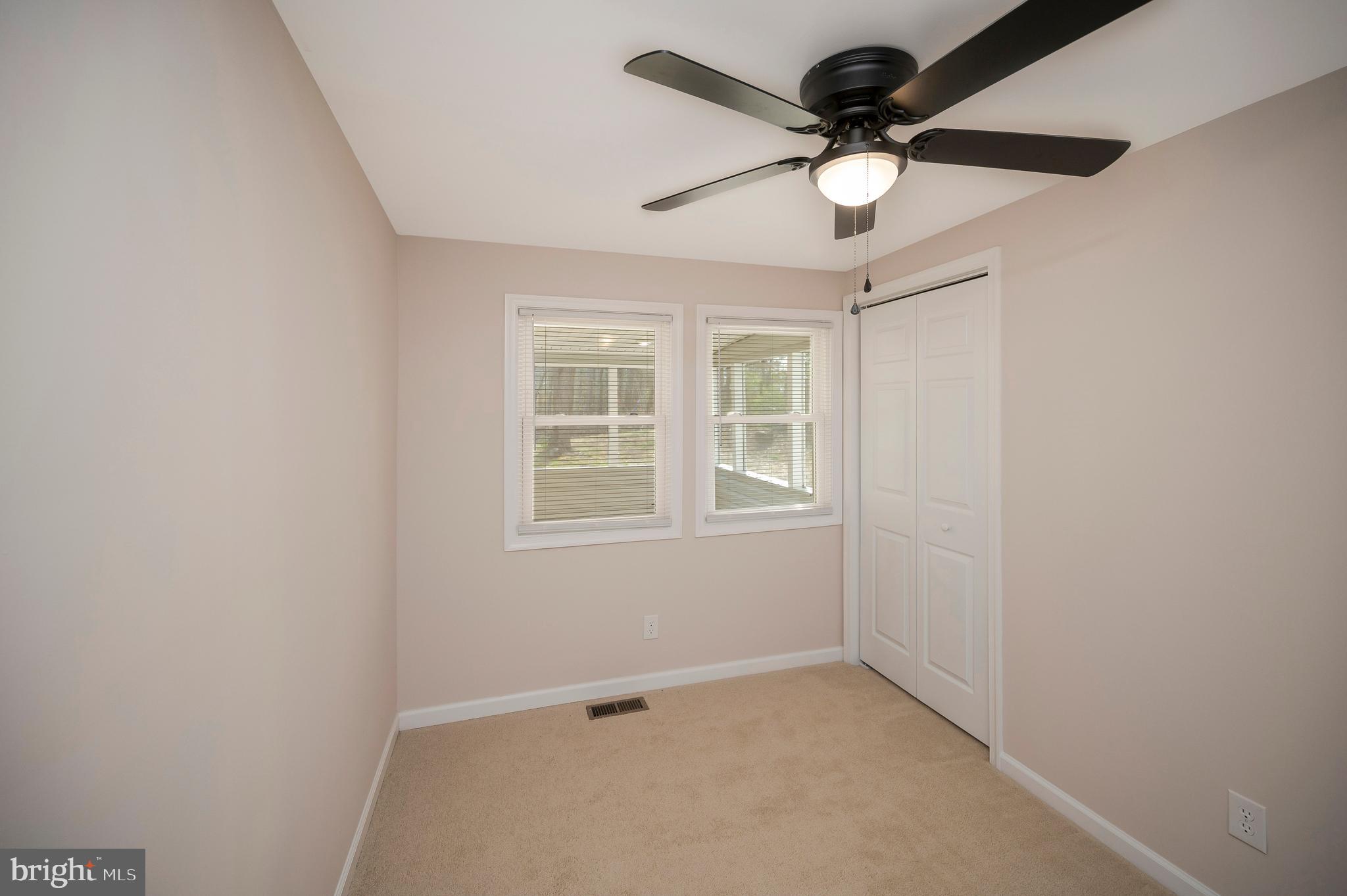 5200 Hams Ford Road Woodford, VA 22580 - Photo 29 of 51 an empty room with windows and ceiling fan