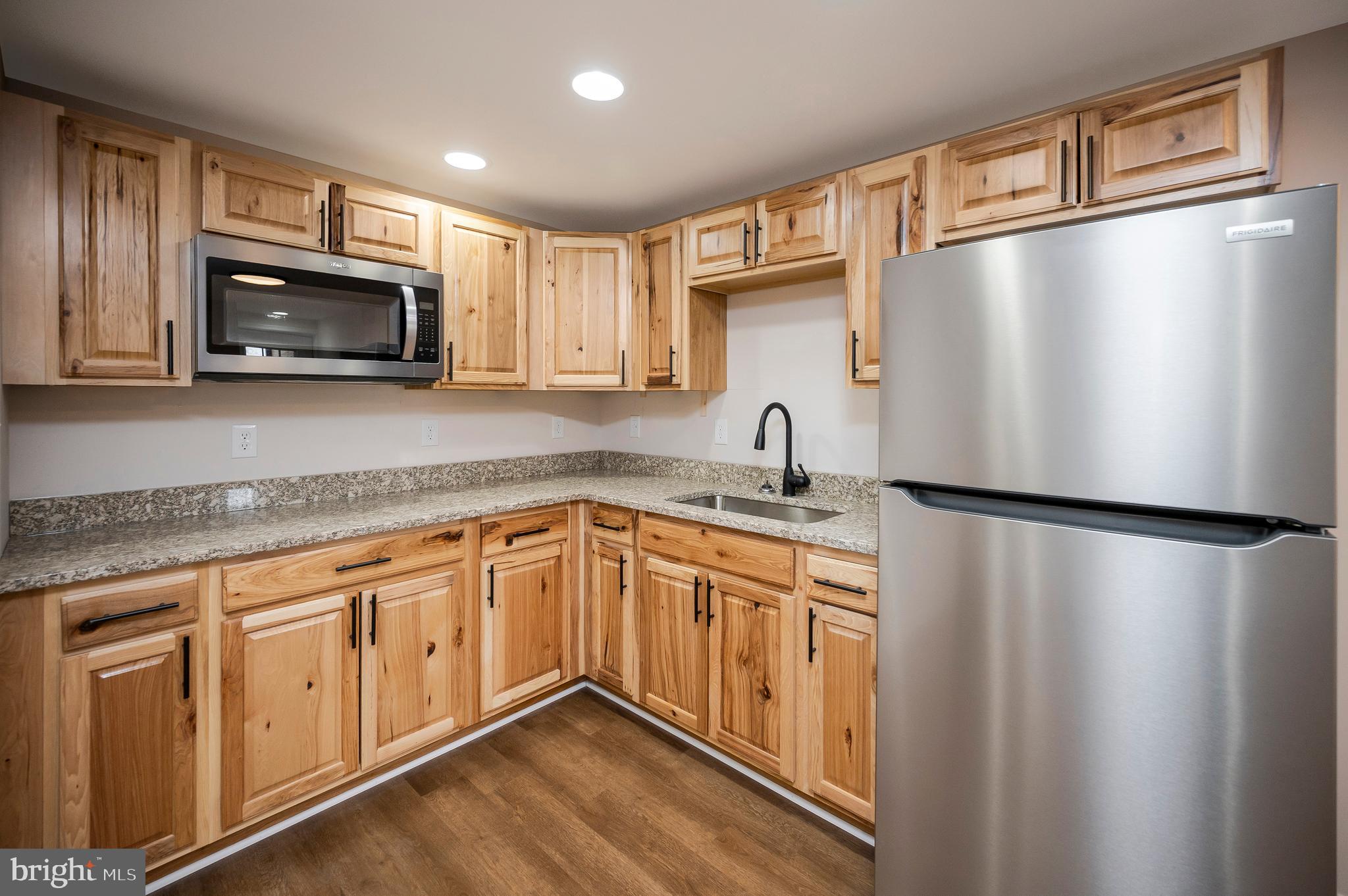 5200 Hams Ford Road Woodford, VA 22580 - Photo 33 of 51 a kitchen with stainless steel appliances granite countertop a refrigerator sink and microwave