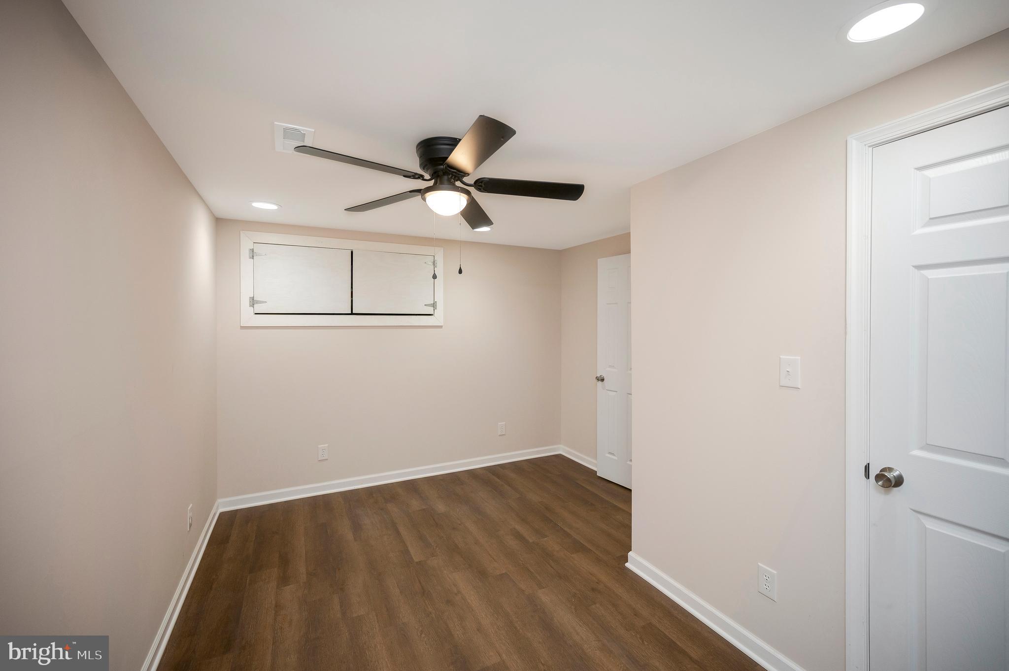 5200 Hams Ford Road Woodford, VA 22580 - Photo 37 of 51 a view of a big room with wooden floor and a ceiling fan