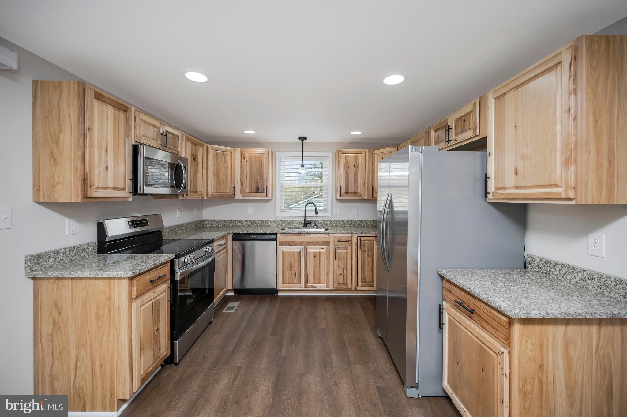 5200 Hams Ford Road Woodford, VA 22580 - Photo 5 of 51 a kitchen with stainless steel appliances granite countertop a stove top oven a sink dishwasher and a refrigerator with wooden cabinets