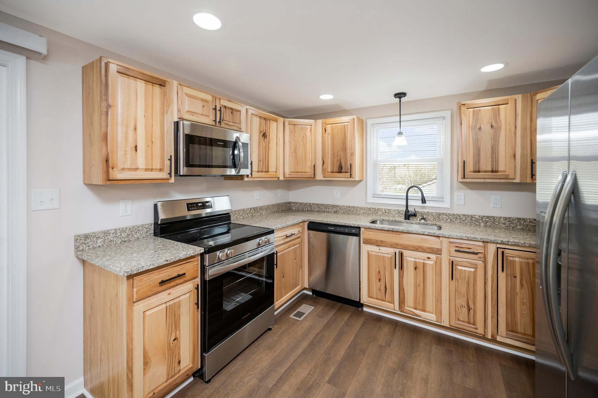5200 Hams Ford Road Woodford, VA 22580 - Photo 7 of 51 a kitchen with stainless steel appliances granite countertop a sink stove and microwave