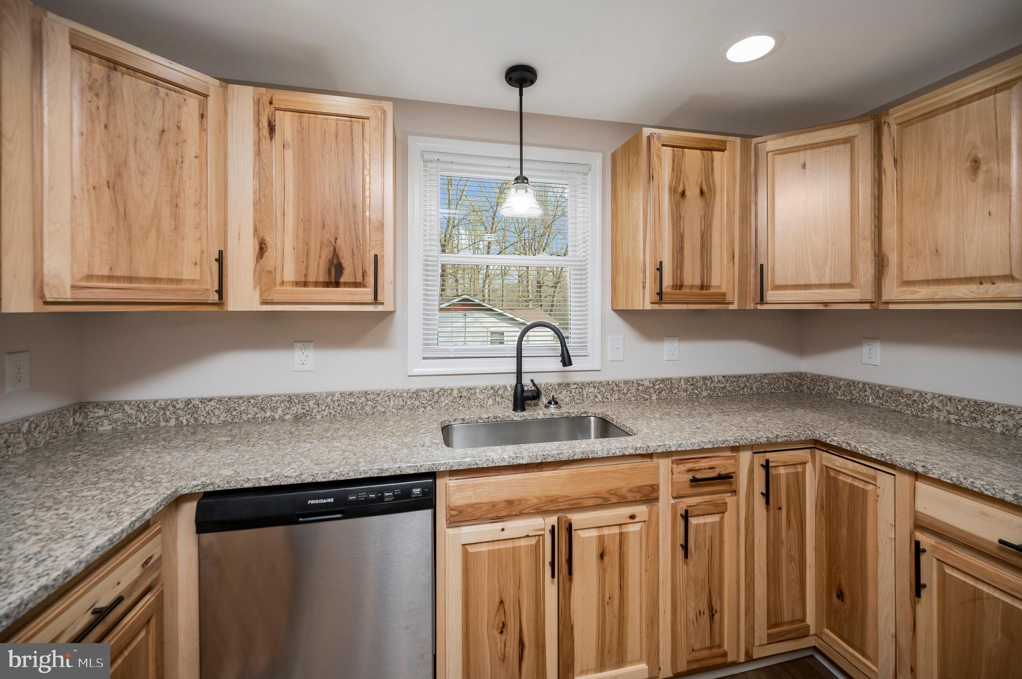 5200 Hams Ford Road Woodford, VA 22580 - Photo 8 of 51 a kitchen with stainless steel appliances granite countertop a sink a window and cabinets