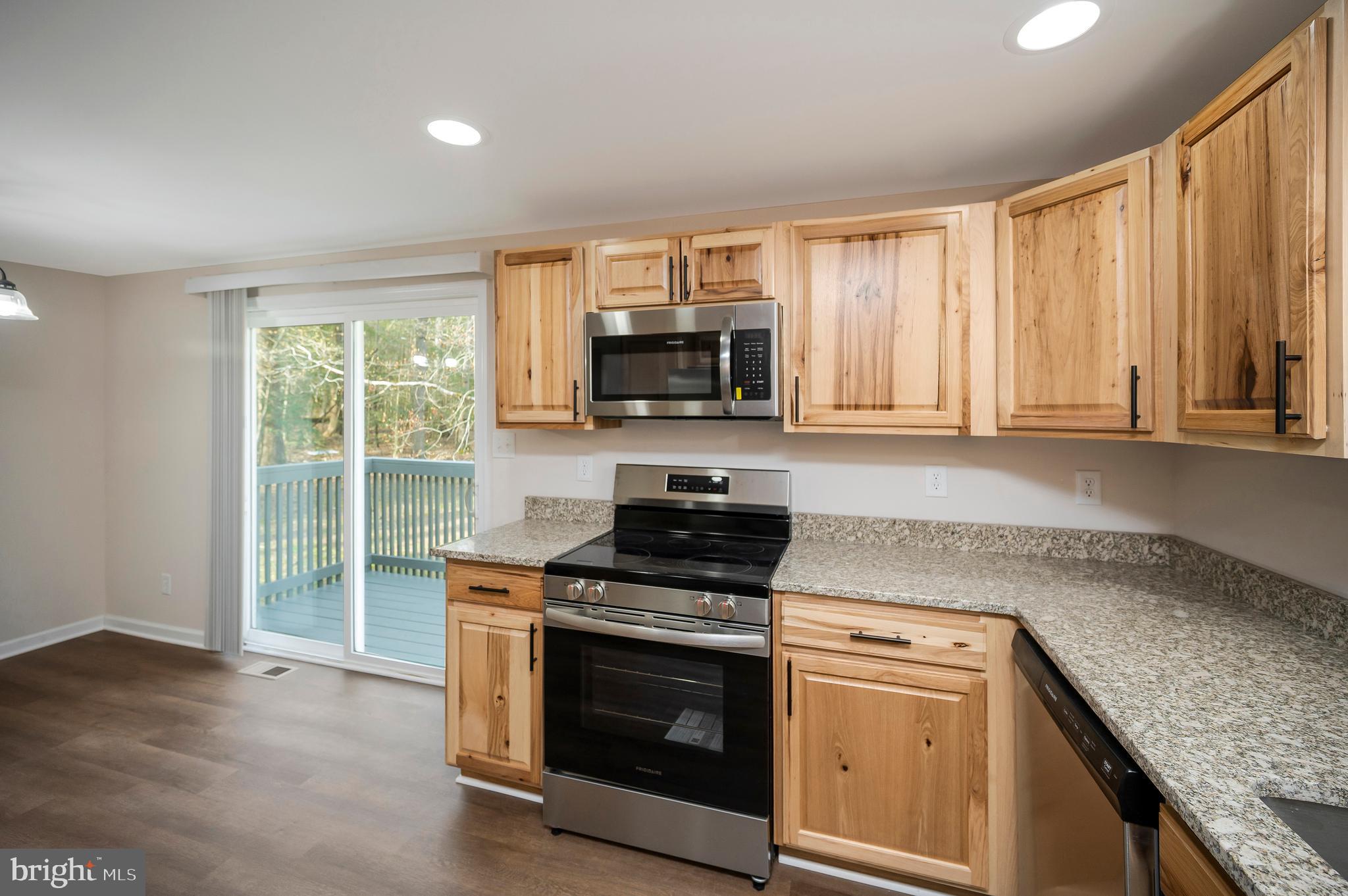 5200 Hams Ford Road Woodford, VA 22580 - Photo 10 of 51 a kitchen with granite countertop a stove and a sink