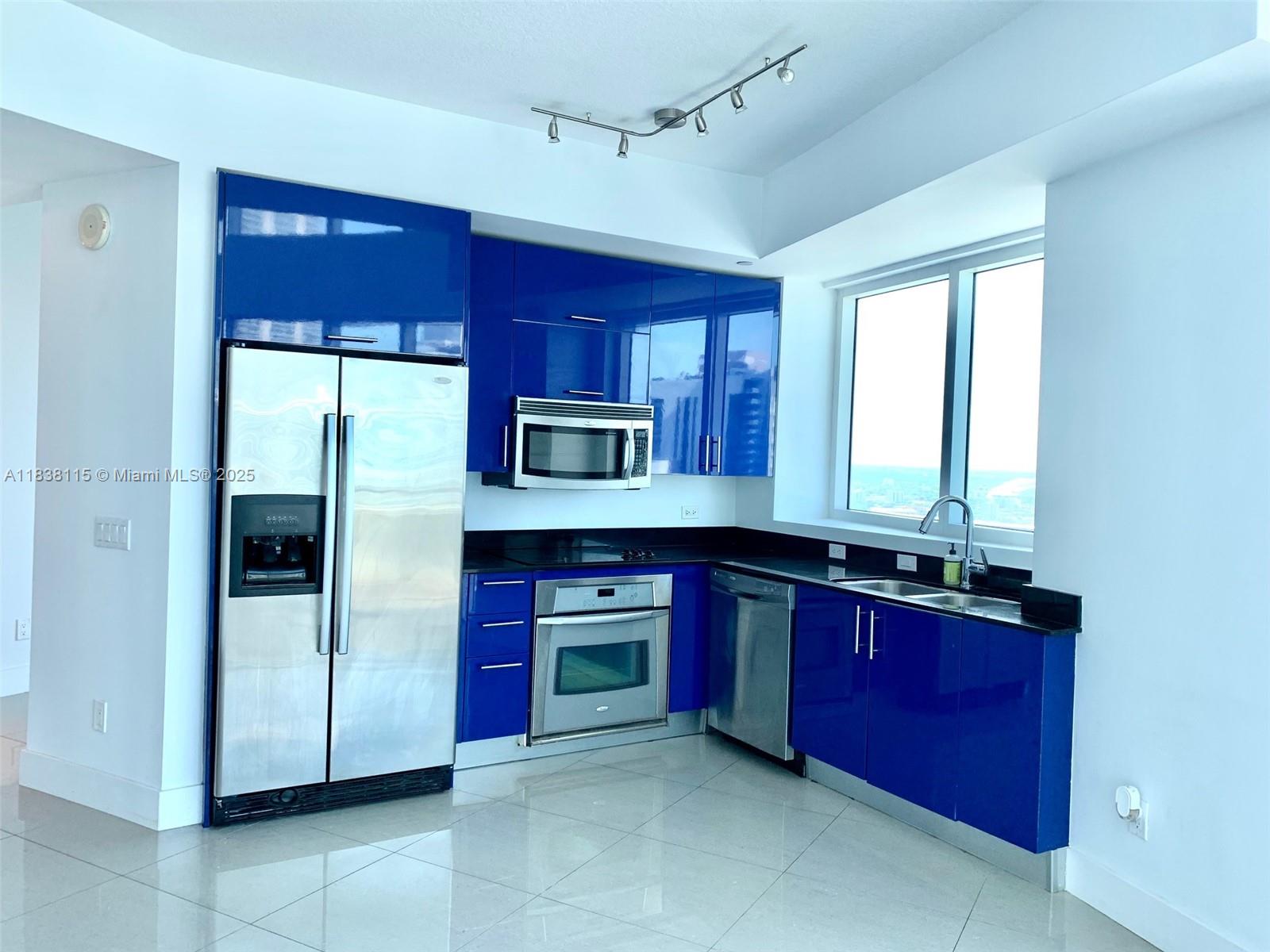 60 Southwest 13th Street, Unit 3826 Miami, FL 33130 - Photo 6 of 29 a kitchen with stainless steel appliances granite countertop a refrigerator and a sink