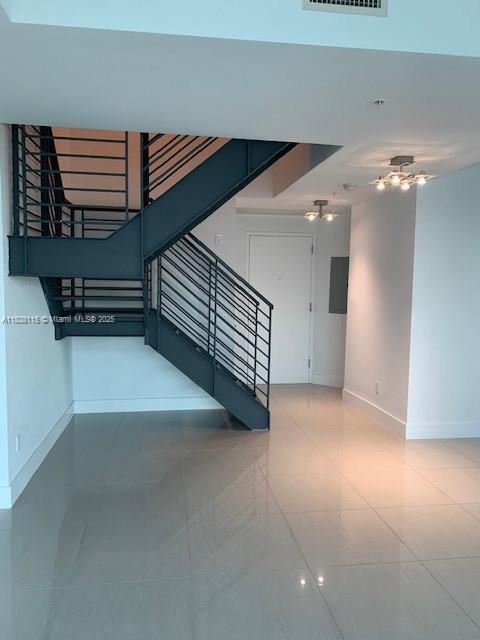 60 Southwest 13th Street, Unit 3826 Miami, FL 33130 - Photo 7 of 29 a view of an empty room with stairs