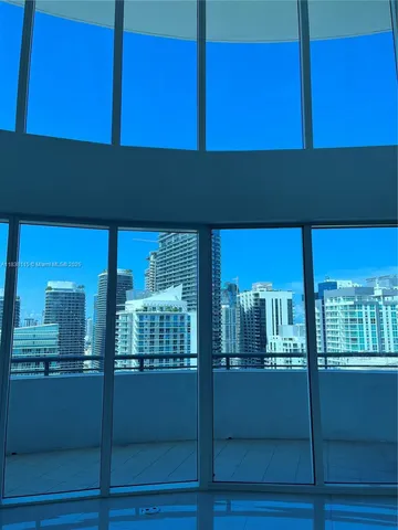 a view of an empty room with windows