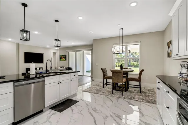a kitchen with granite countertop a sink a center island and furniture