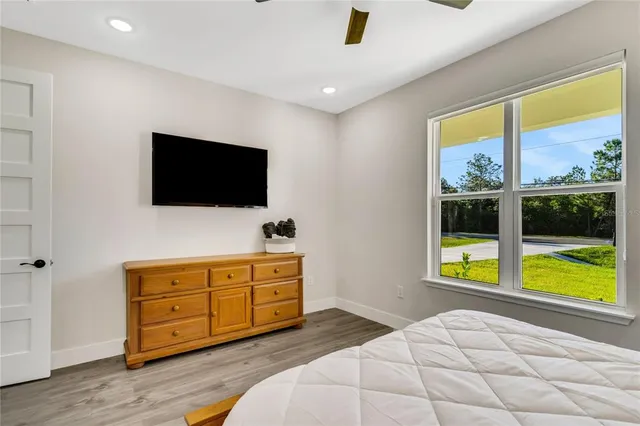 a bedroom with a bed and a television