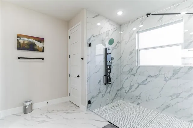 a bathroom with a shower and a sink