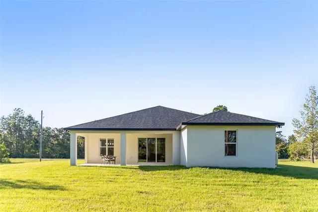 a front view of the house with a yard