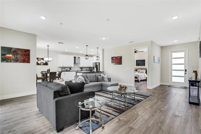 a living room with furniture and wooden floor