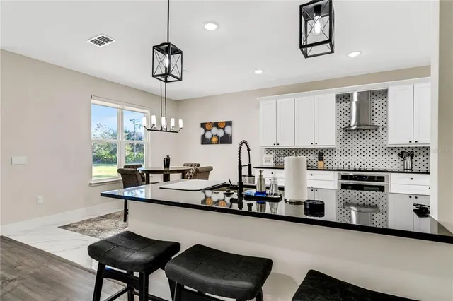 a kitchen with stainless steel appliances a sink and cabinets