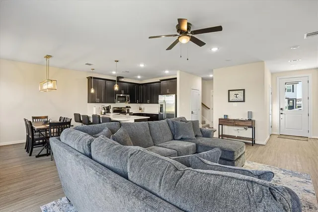 a living room with furniture and kitchen view