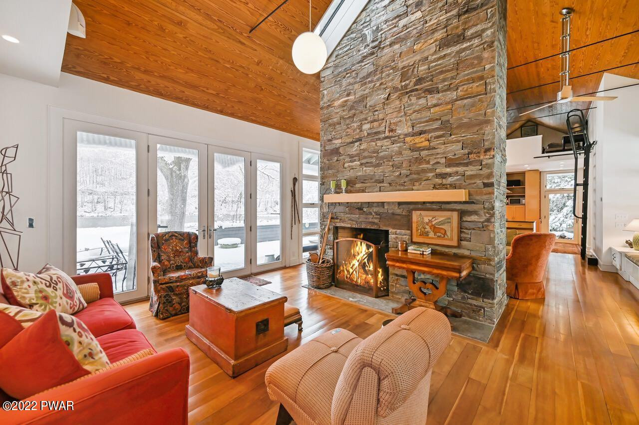 45 Tammany Flats Road Damascus, PA 18415 - Photo 20 of 73 a living room with furniture a fireplace and floor to ceiling windows
