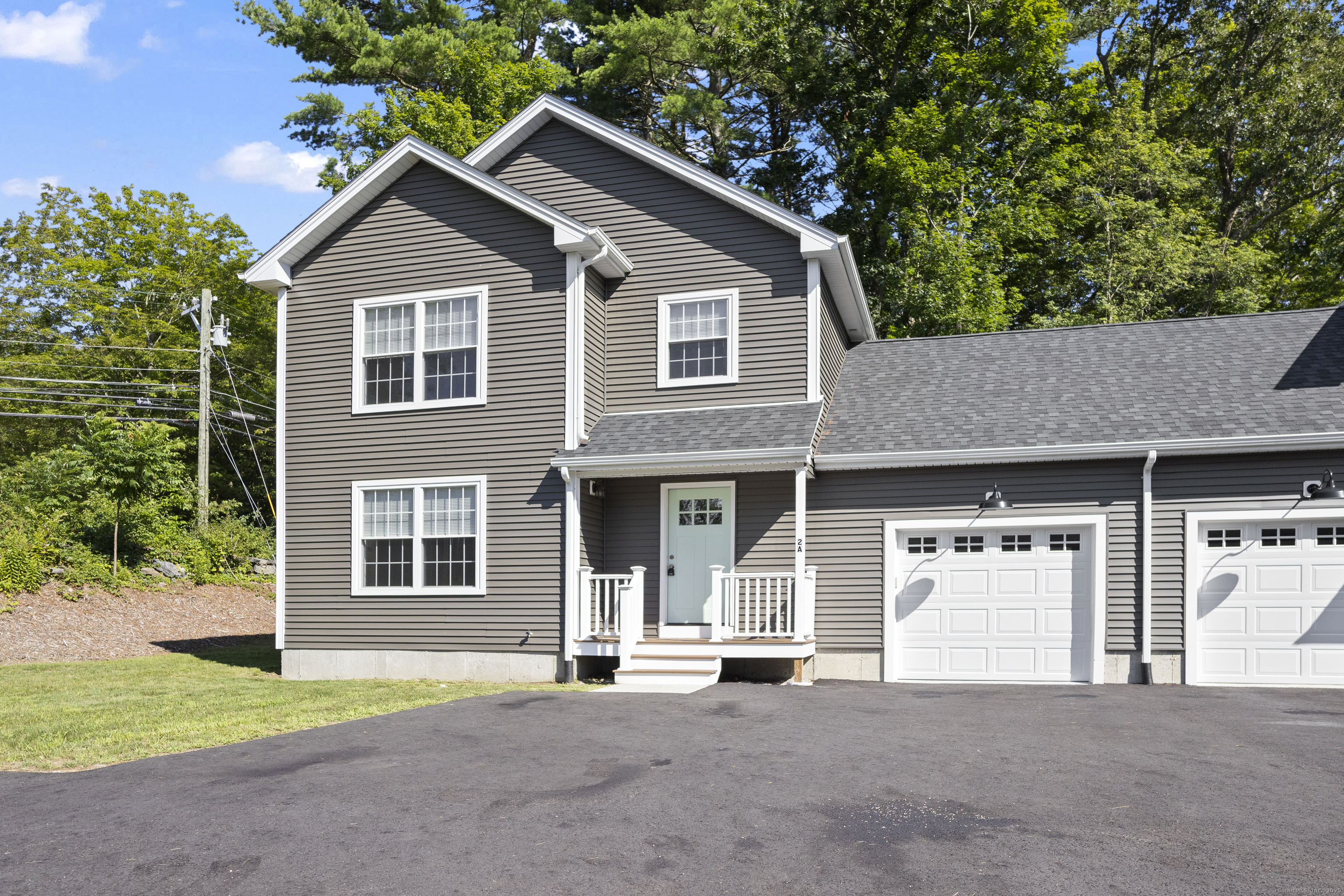 a view of a house with a yard and garage