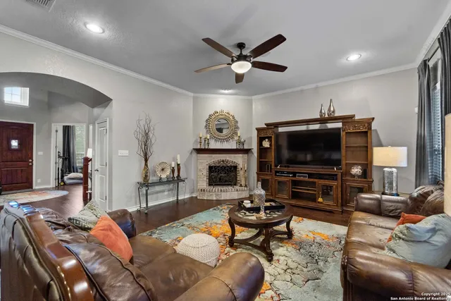 a living room with furniture a flat screen tv and a fireplace