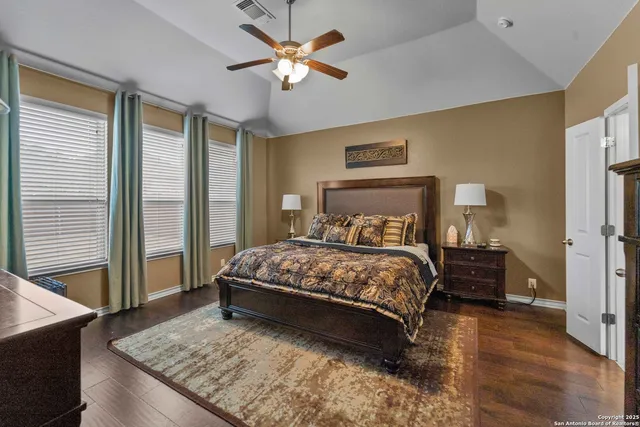 a bedroom with a large bed and a chandelier