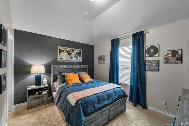 a bedroom with a bed and lamp