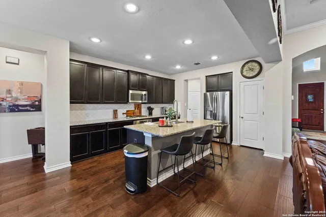 a kitchen with a sink appliances and cabinets