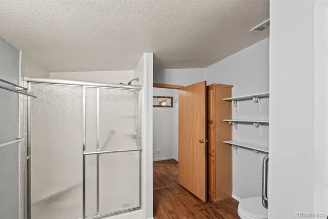 a bathroom with a shower and a glass door