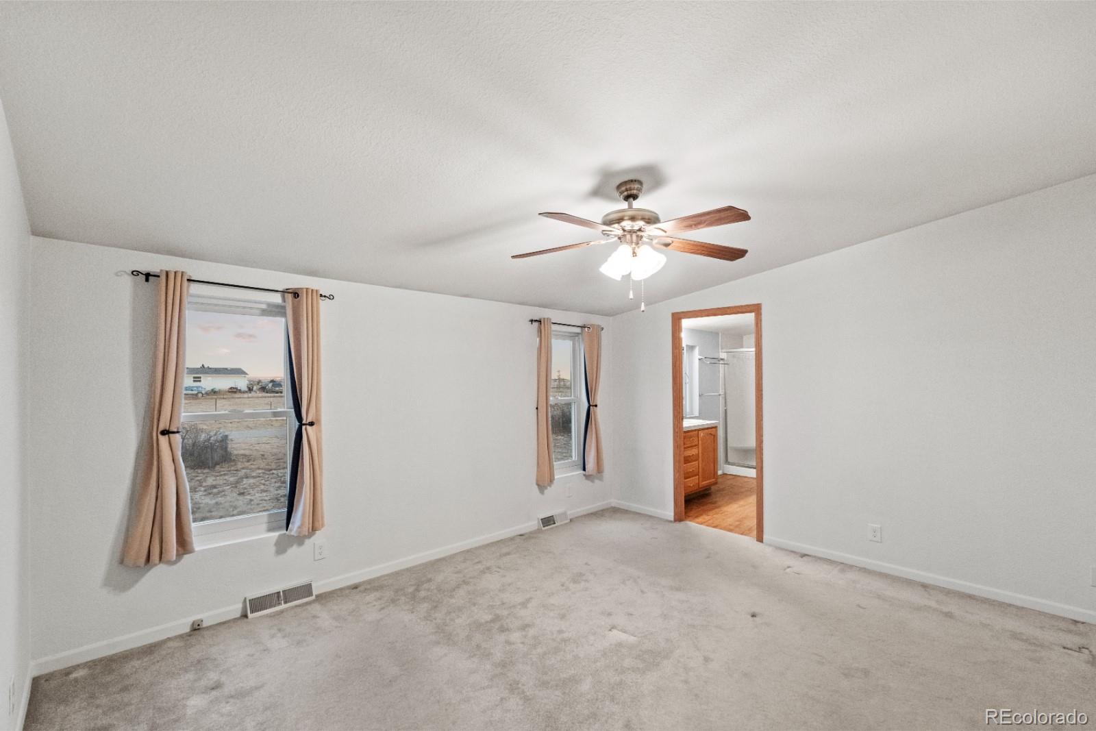 21105 McDaniels Road Calhan, CO 80808 - Photo 12 of 32 a view of an empty room with closet and a chandelier fan