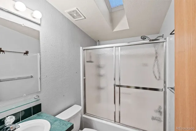 a bathroom with a shower and toilet