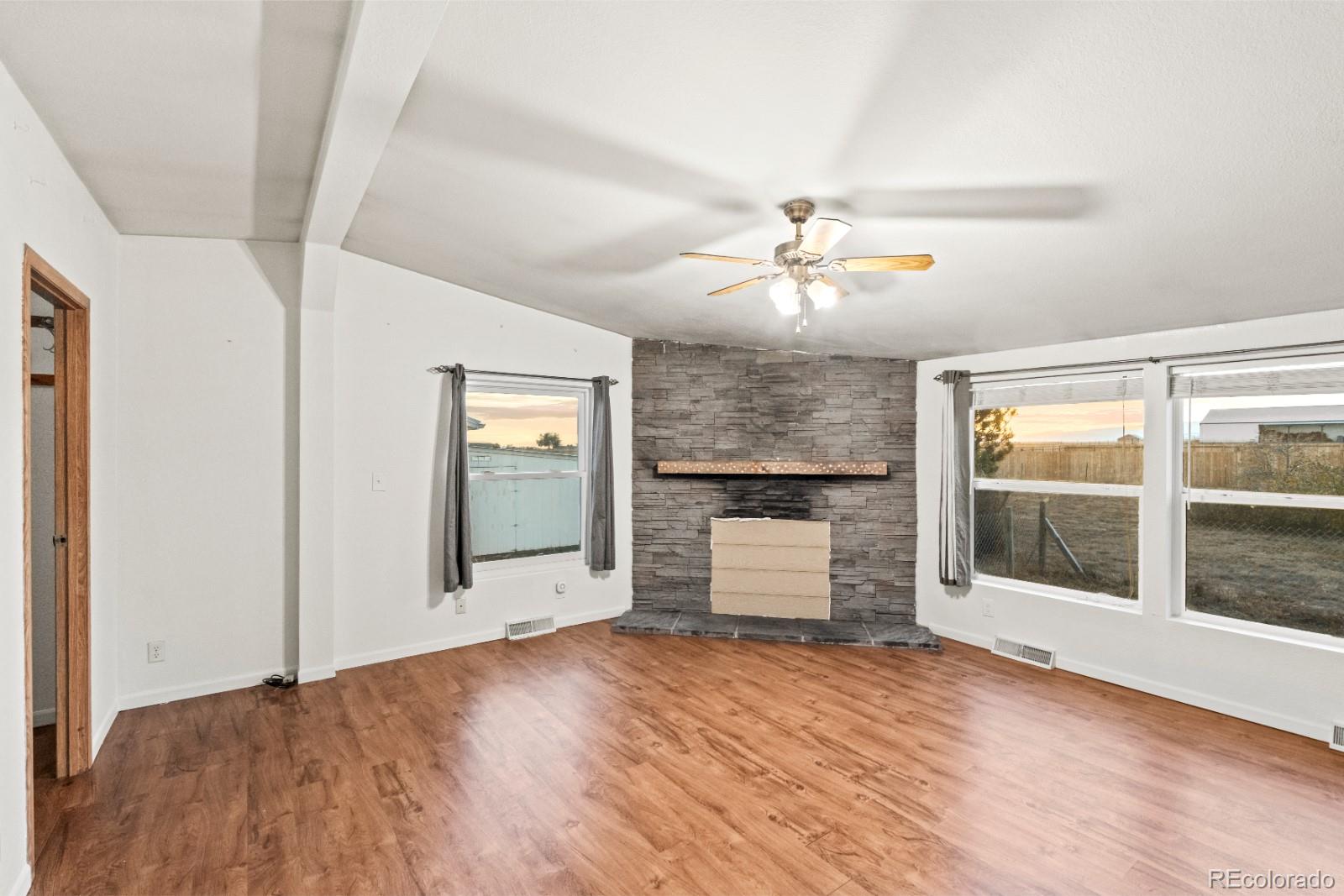 21105 McDaniels Road Calhan, CO 80808 - Photo 2 of 32 wooden floor in an empty room with a window