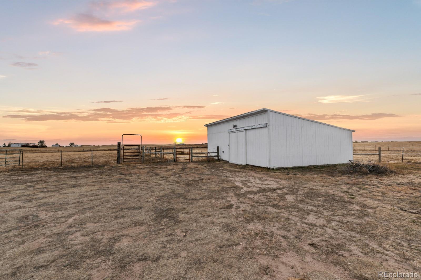 21105 McDaniels Road Calhan, CO 80808 - Photo 21 of 32 a view of a dry yard with wooden fence