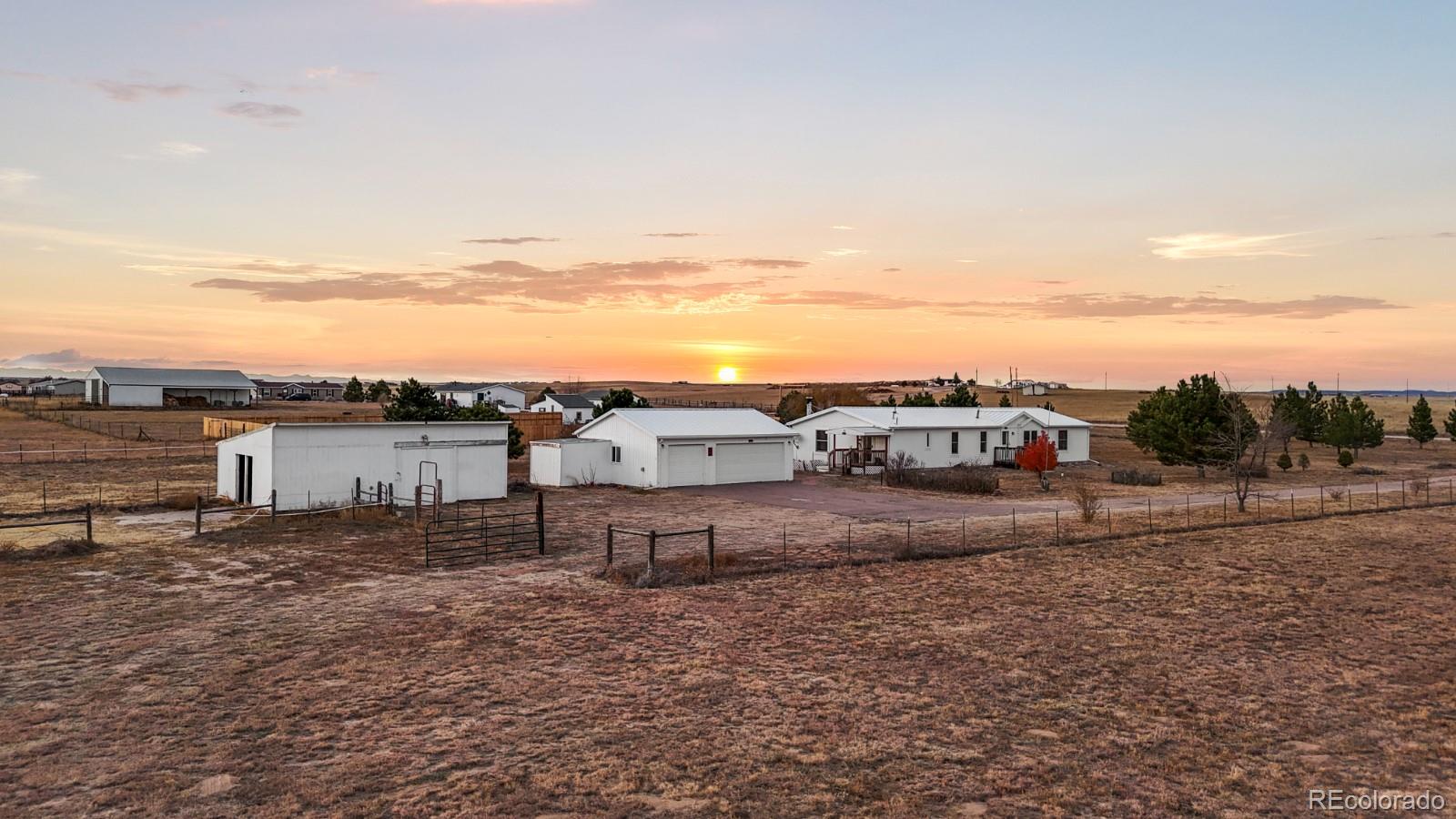 21105 McDaniels Road Calhan, CO 80808 - Photo 32 of 32 a view of a dry yard with wooden fence