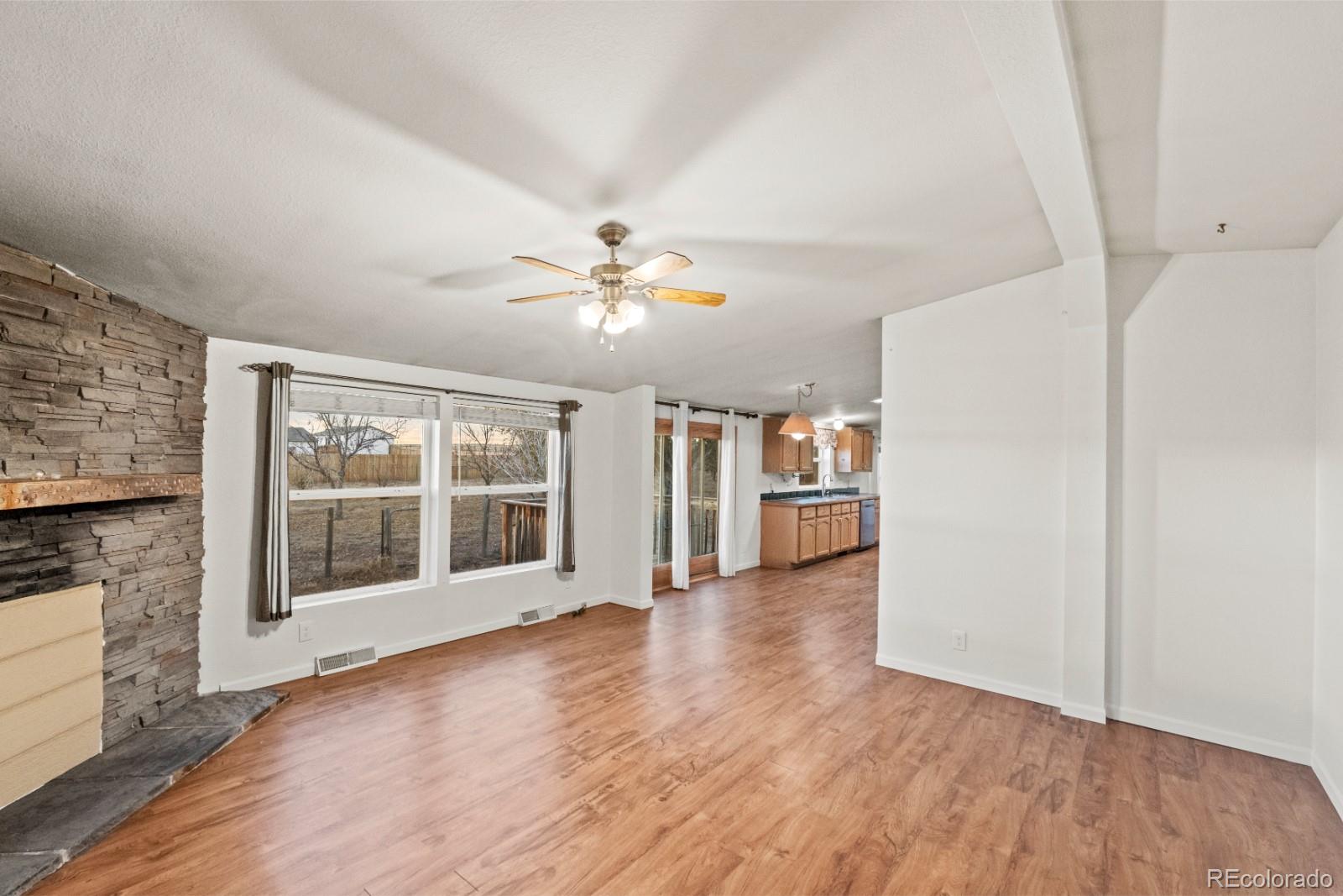 21105 McDaniels Road Calhan, CO 80808 - Photo 5 of 32 wooden floor in an empty room with a window