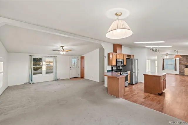 a view of a kitchen with a sink stainless steel appliances and cabinets