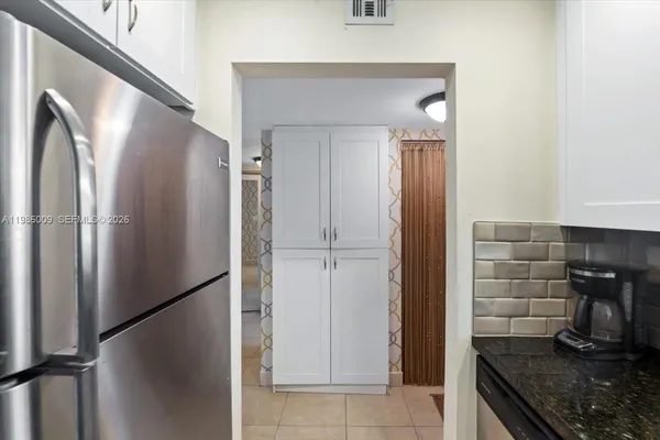 a kitchen with stainless steel appliances granite countertop a refrigerator and a stove