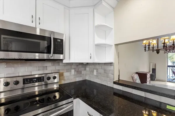 a kitchen with a stove and a microwave