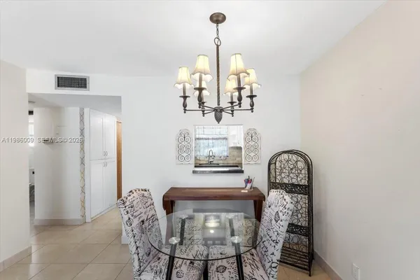 a view of a dining room with furniture and chandelier