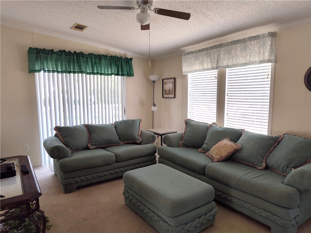 7490 133rd Place Sebastian, FL 32958 - Photo 5 of 25 a living room with furniture and a window