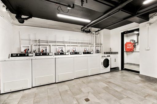 5858 North Sheridan Road, Unit 508 Chicago, IL 60660 - Photo 17 of 17 a kitchen with white cabinets and white appliances