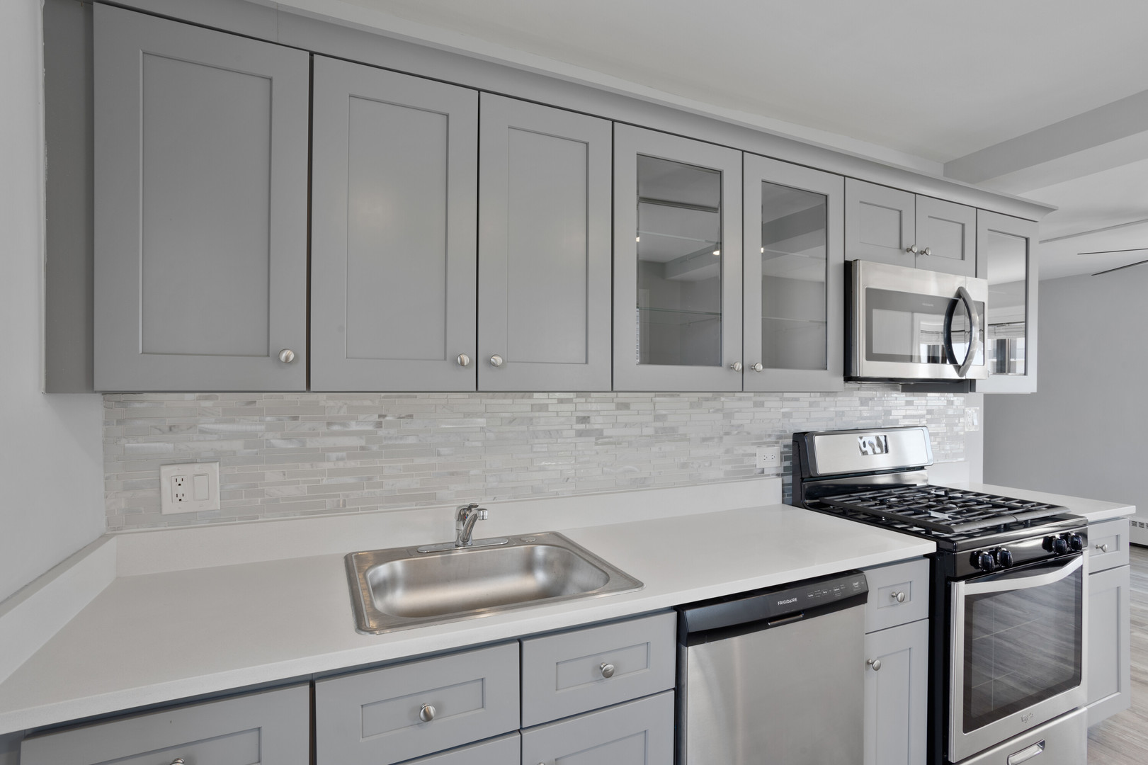 5858 North Sheridan Road, Unit 508 Chicago, IL 60660 - Photo 3 of 17 a kitchen with white cabinets and a sink